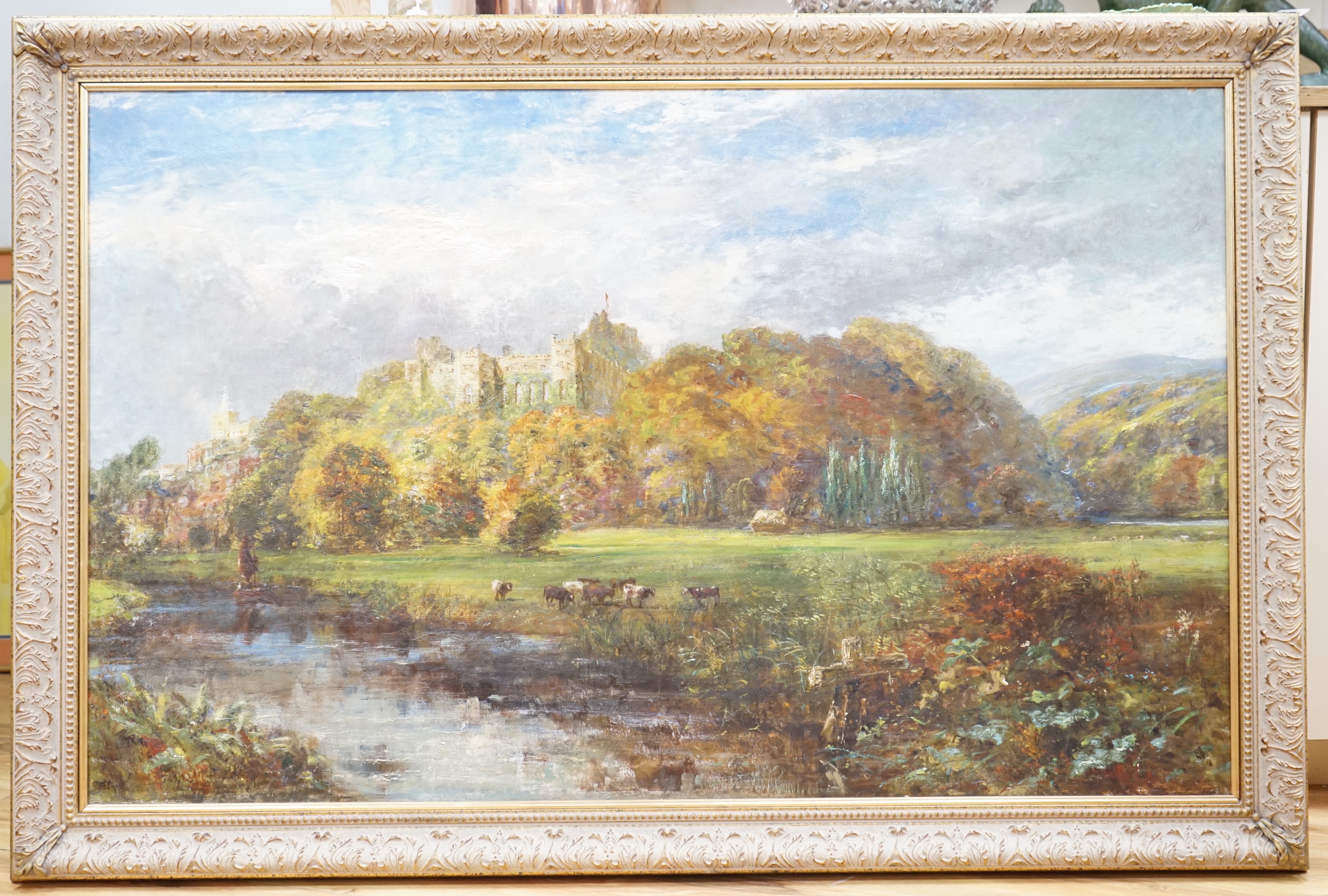 19th century English School, oil on canvas, River scene with cattle, a castle ruin in the background, possibly signed lower left, 110 x 70cm